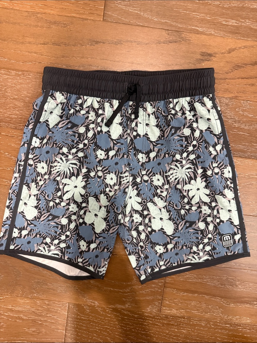 Travis Mathew Black Waistband Blue and White Tropical Floral Swim Trunks